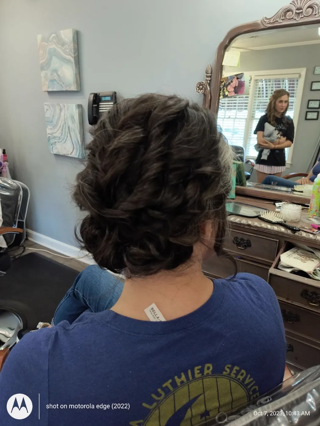 Elegant braided updo styled for a special occasion, back view