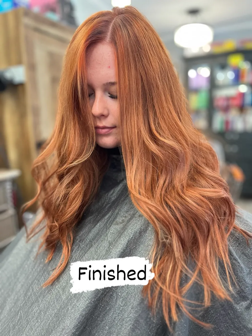 Vivid copper red color on long layered hair