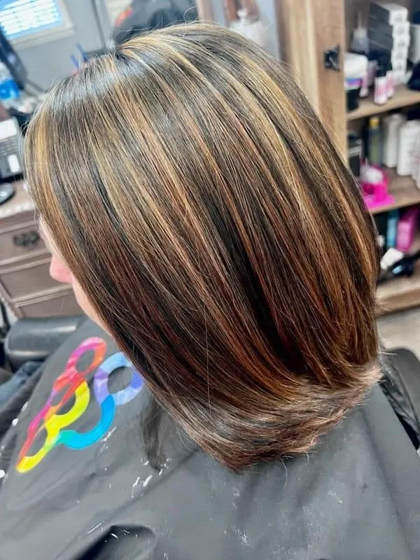 Dimensional caramel highlights on a sleek bob
