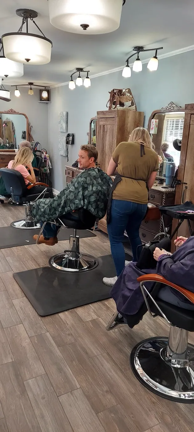 Stylists working at rustic wood styling stations inside Kozo Salon & Spa