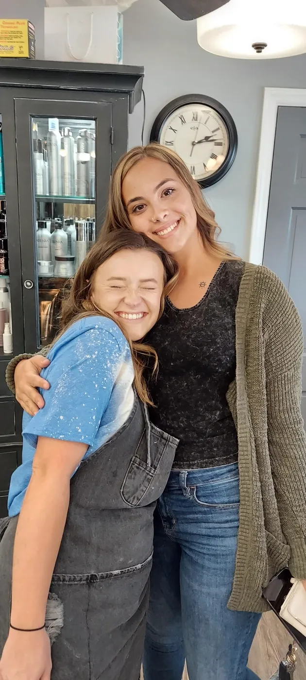 Two Kozo stylists sharing a hug between appointments